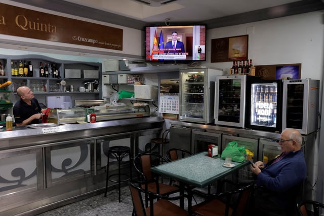 A waiter watches a TV broadcasting of a statement by Spain's Prime Minister Pedro Sanchez in a bar, in Ronda, Spain, April 29, 2024. REUTERS/Jon Nazca/File Photo