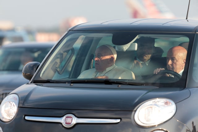 Pope Francis sits in a vehicle ahead of his departure for a visit to Luxembourg and Belgium, at Fiumicino airport in Rome, Italy, September 26, 2024. REUTERS/Remo Casilli