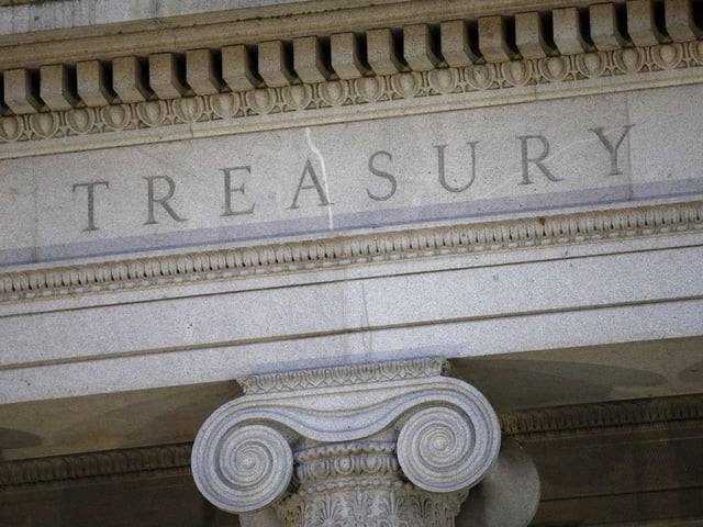 FILE- This photo shows the U.S. Treasury Department building at dusk in Washington, June 6, 2019.