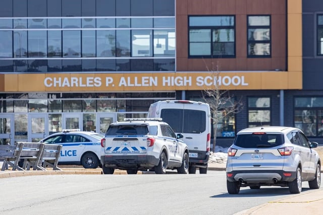 Police monitor the situation at Charles P. Allen High School in Halifax, Monday, March 20, 2023. THE CANADIAN PRESS/Riley Smith