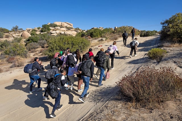 Colombian asylum seekers walk along a desert road after crossing the U.S.-Mexico on Sept. 22, 2024 near Jacumba Hot Springs, Calif. 