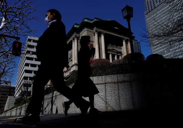 Pedestrians walk past the Bank of Japan building in Tokyo, Japan March 18, 2024. REUTERS/Kim Kyung-Hoon/File Photo