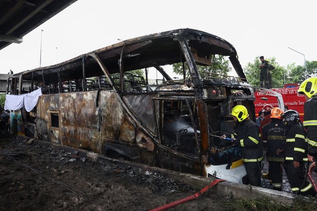 Firefighters work to extinguish a burning bus that was carrying teachers and students from Wat Khao Phraya school, reportedly killing almost a dozen, on the outskirts of Bangkok, Thailand, October 1, 2024. REUTERS/Chalinee Thirasupa