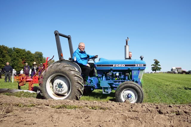 Ontario Premier Doug Ford plows a field with a tractor at the 2023 International Plowing Match and Rural Expo, in Bowling Green, Ont., Tuesday, Sept. 19, 2023.