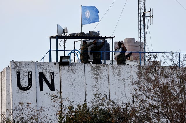 Members of the United Nations peacekeepers (UNIFIL) look at the Lebanese-Israeli border, as they stand on the roof of a watch tower ‏in the town of Marwahin, in southern Lebanon, October 12, 2023. REUTERS/Thaier Al-Sudani/File Photo