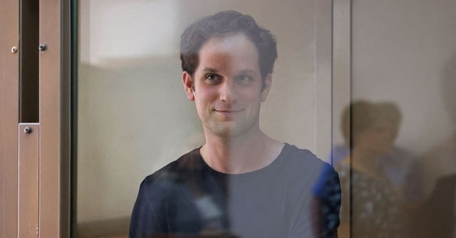 Wall Street Journal reporter Evan Gershkovich, who was arrested in March while on a reporting trip and accused of espionage, stands behind a glass wall of an enclosure for defendants before a court hearing to consider an appeal against his detention, in Moscow, Russia June 22, 2023. REUTERS/Evgenia Novozhenina/File photo