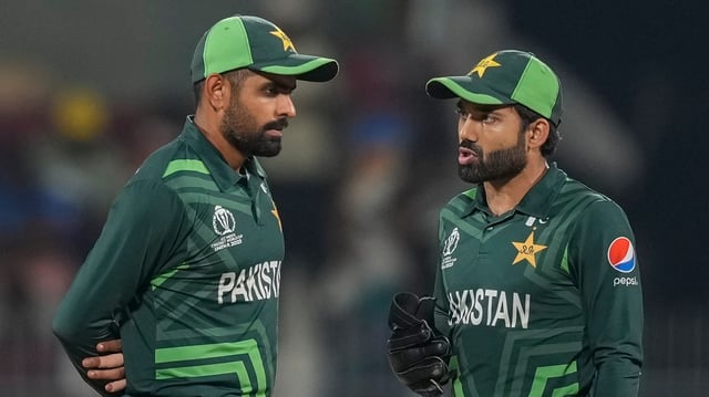 Pakistan's captain Babar Azam and wicketkeeper Mohammad Rizwan talk during the ICC Men's Cricket World Cup