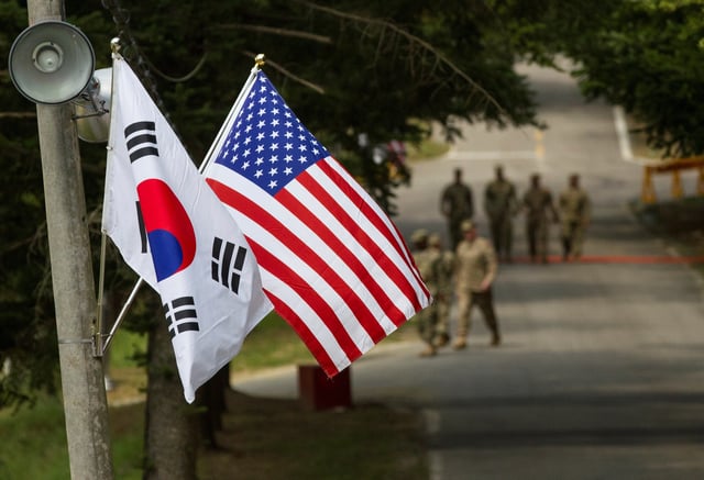 The South Korean and American flags fly next to each other at Yongin, South Korea, August 23, 2016. Courtesy Ken Scar/U.S. Army/Handout via REUTERS/ File Photo