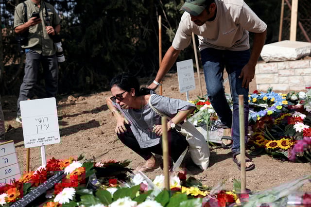 Friends and family mourn Smadar Idan and Roee Idan, who were killed following the deadly infiltration by Hamas gunmen from the Gaza Strip while two of their children hid in a closet, and after Roee, who was a news photographer, documented the infiltration before he was shot, and their three-year-old daughter, Avigail, remains unaccounted for, at their funeral in Kfar Harif, Israel, October 20, 2023. REUTERS/Violeta Santos Moura/File Photo