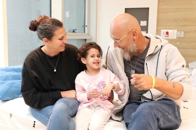 Abigail Edan, who was released after being taken hostage during the October 7 attack on Israel by the Palestinian militant group Hamas, talks with her aunt Liron and uncle Zuli, at Schneider Children's Medical Center of Israel in Petah Tikva, Israel, in this handout picture released by Schneider Children's Medical Center of Israel on November 27, 2023.  Schneider Children's Medical Center of Israel/Handout via REUTERS /File Photo