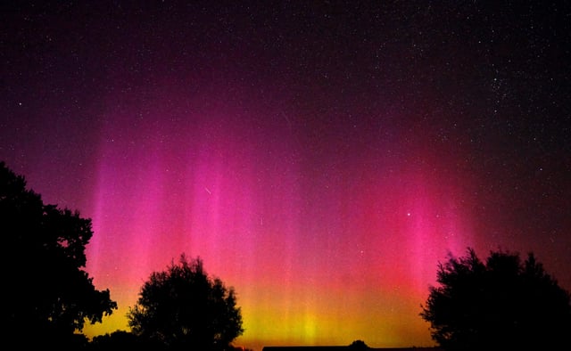 The northern lights (aurora borealis) illuminating the sky above Guelpe by Havelaue in the Dark-sky preserve Westhavelland in eastern Germany, during the annual Perseids meteor shower on August 13, 2024.