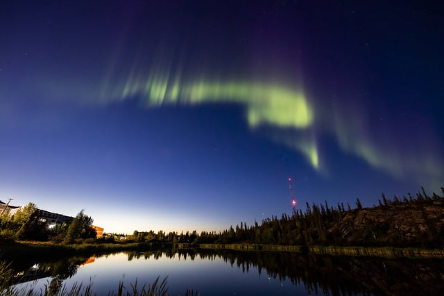 The northern lights, or the aurora borealis, appear in the sky over Rat Lake in Yellowknife, Northwest Territories on Thursday, Aug.8, 2024. THE CANADIAN PRESS/Bill Braden