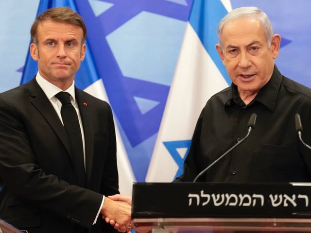 TOPSHOT - Israeli Prime Minister Benjamin Netanyahu (R) shakes hands with French President Emmanuel Macron (L) after their joint press conference in Jerusalem on October 24, 2023. Macron's visit comes more than two weeks after Hamas militants stormed into Israel from the Gaza Strip and killed at least 1,400 people, according to Israeli officials while Israel continues a relentless bombardment of the Gaza Strip and prepares for a ground offensive with more than 5,000 Palestinians, mainly civilians, killed so far across the Palestinian territory, according to the latest toll from the Hamas health ministry in Gaza. (Photo by Christophe Ena / POOL / AFP) (Photo by CHRISTOPHE ENA/POOL/AFP via Getty Images)