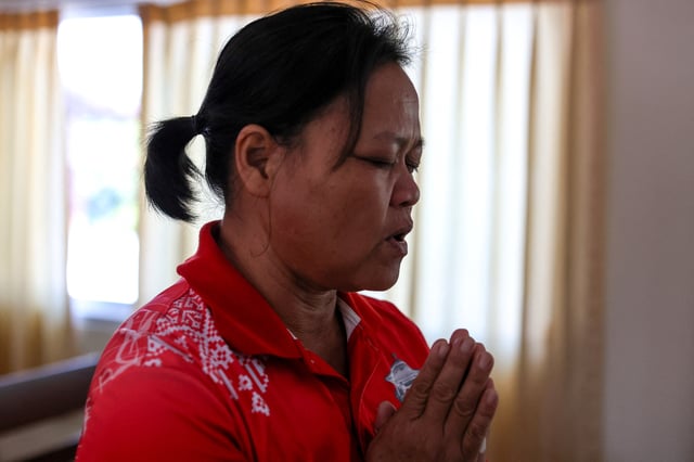 Wiwwaro Sriaoun, 53, a mother of a remaining Thai hostage captured by Hamas, Watchara Sriaoun, attends Sunday church service, in Kut Yang village, Udon Thani province, Thailand, October 6, 2024. REUTERS/Thomas Suen