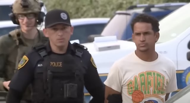 police arresting migrant