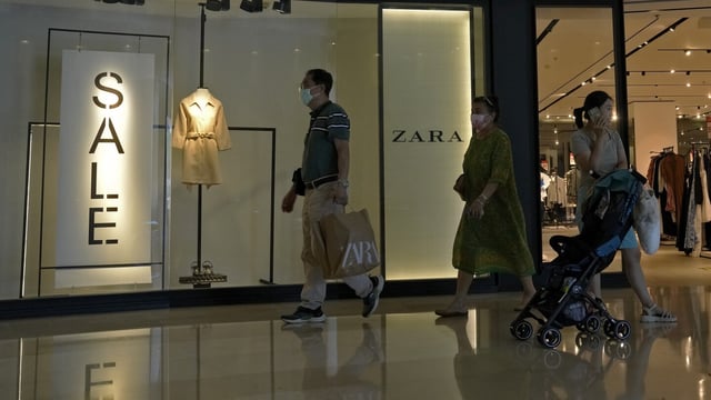 FILE - A man with a shopping bag walks out from a ZARA flagship store at a shopping mall in Beijing, on June 21, 2023. American companies operating in China view tensions with Washington over technology, trade and other issues as a major hindrance for their businesses there, according to a survey by the American Chamber of Commerce in Shanghai. (AP Photo/Andy Wong, File)