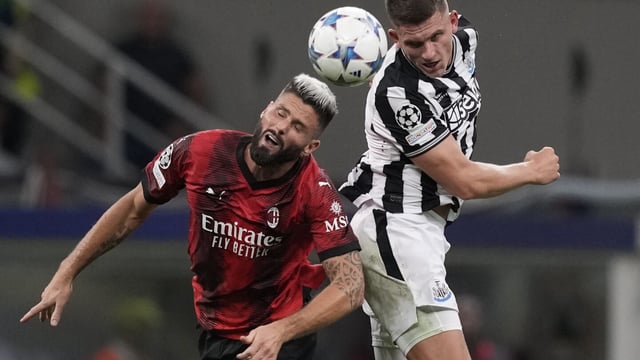 AC Milan's Olivier Giroud, left, goes for the header with Newcastle's Sven Botman during the Champions League group F soccer match between AC Milan and Newcastle at the San Siro stadium in Milan, Italy, Tuesday, Sept. 19, 2023. (AP Photo/Antonio Calanni)