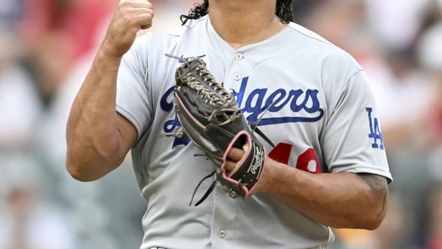 Los Angeles Dodgers relief pitcher Brusdar Graterol celebrates the last out of the eighth inning in the continuation of a suspended baseball game against the Cleveland Guardians, Thursday, Aug. 24, 2023, in Cleveland. The game was suspended the night before due to inclement weather. (AP Photo/Nick Cammett)