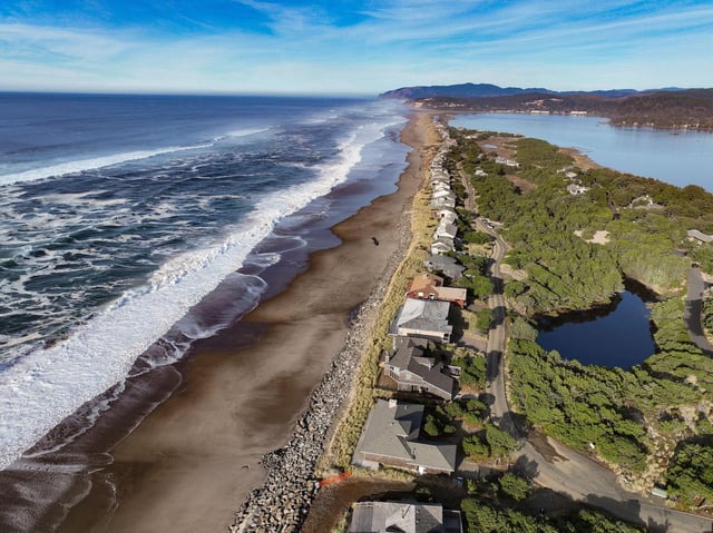 Rock shoreline structures to prevent sea level rise on the US pacific coast. Credit: Ken Hawkins / Alamy Stock Photo.