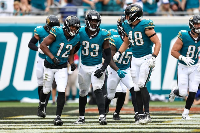 Oct 6, 2024; Jacksonville, Florida, USA; Jacksonville Jaguars wide receiver Devin Duvernay (12) and linebacker Devin Lloyd (33) celebrate after a play against the Indianapolis Colts in the third quarter at EverBank Stadium. Mandatory Credit: Nathan Ray Seebeck-Imagn Images/File Photo
