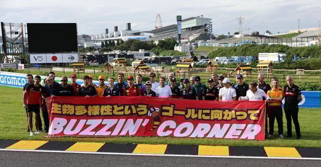 Formula One F1 - Japanese Grand Prix - Suzuka Circuit, Suzuka, Japan - September 21, 2023 Former driver Sebastian Vettel poses with drivers and team members as he launches 'Buzzin' Corner' a project to raise awareness about the importance of biodiversity REUTERS/Issei Kato