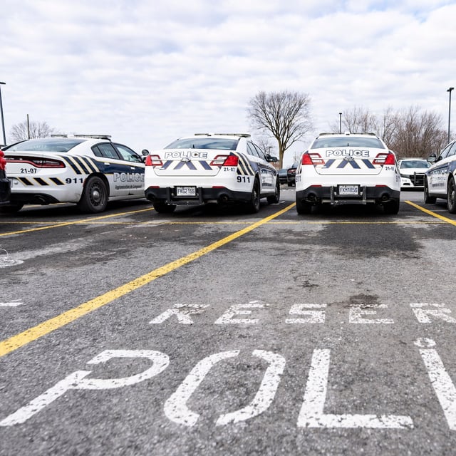 A woman from Montreal's South Shore has been charged with aggravated assault after allegedly splashing a 10-year-old boy with boiling water. Longueuil police vehicles are parked in Longueuil, Que., Monday, March 4, 2024. THE CANADIAN PRESS/Christinne Muschi