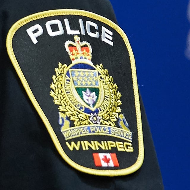 A Winnipeg Police Service shoulder badge is seen in Winnipeg on Sept. 2, 2021. A man and a woman in Winnipeg face numerous animal cruelty charges in a case where police allege cats were tortured and videos and photos of the incidents were posted to the internet. THE CANADIAN PRESS/David Lipnowski