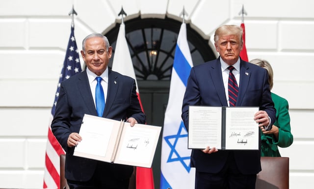Israel's Prime Minister Benjamin Netanyahu stands with U.S. President Donald Trump after signing the Abraham Accords, normalizing relations between Israel and some of its Middle East neighbors,  in a strategic realignment of Middle Eastern countries against Iran, on the South Lawn of the White House in Washington, U.S., September 15, 2020. REUTERS/Tom Brenner/File Photo