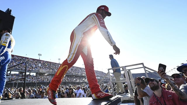 Bubba Wallace greets fans prior to a NASCAR Cup Series auto race at Darlington Raceway, Sunday, Sept. 3, 2023, in Darlington, S.C. (AP Photo/Matt Kelley)