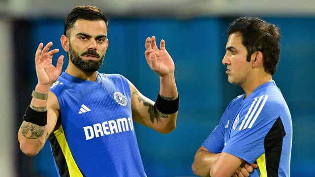 India's Virat Kohli talks with head coach Gautam Gambhir (R) during a practice session.