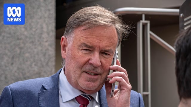 Gregory Geason on mobile phone outside court.