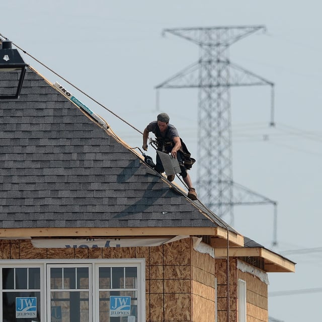 A construction worker shingles the roof of a new home in a housing development in Ottawa on Monday, July 6, 2015. Statistics Canada is set to release its August labour force survey this morning. THE CANADIAN PRESS/Sean Kilpatrick
