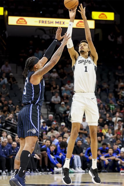 San Antonio Spurs center Victor Wembanyama wants a court to award him any profits that James T. Glodich made from selling merchandise using the player&#39;s name and image. Wembanyama is shown shooting over Orlando Magic forward Paolo Banchero during a preseason game last week in San Antonio.