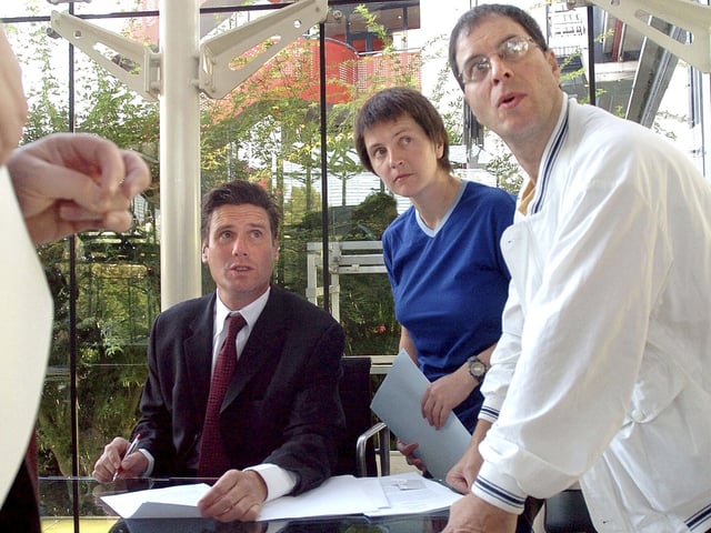 FILE - British environmental activists Helen Steel, second right, and David Morris, right, discuss with their lawyer Keir Starmer, seated, as they wait for the beginning of their hearing at the European Court for Human Rights Tuesday Sept. 7, 2004, in Strasbourg, eastern France. (AP Photo/Christian Lutz, File)