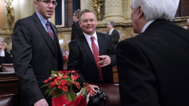 FILE - Pennsylvania Rep. Ryan Bizzarro, D-Erie, left, meets with fellow House members Rep. Patrick Harkins, D-Erie, center and Rep. Florindo Fabrizio, D-Erie, right, prior to being sworn into office, Jan. 1, 2013 in Harrisburg, Pa. The Democratic Pennsylvania state lawmaker has announced he plans to run for treasurer, positioning himself as an ideological opposite to the Republican incumbent regarding abortion access and the 2020 election. Rep. Bizzarro announced his candidacy Tuesday, Sept. 26, 2023 in next year's primary. First-term incumbent Stacy Garrity, a Republican, has said she plans to run for a second term. (AP Photo/Bradley C Bower, file)