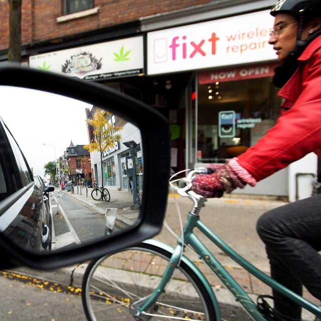Ontario's municipalities say the upcoming legislation requiring provincial approval to install bike lanes that remove a lane for cars is a "significant overreach" of power. A cyclist rides on the designated Bloor Street bike lane in Toronto on Thursday, October 12, 2017. THE CANADIAN PRESS/Nathan Denette