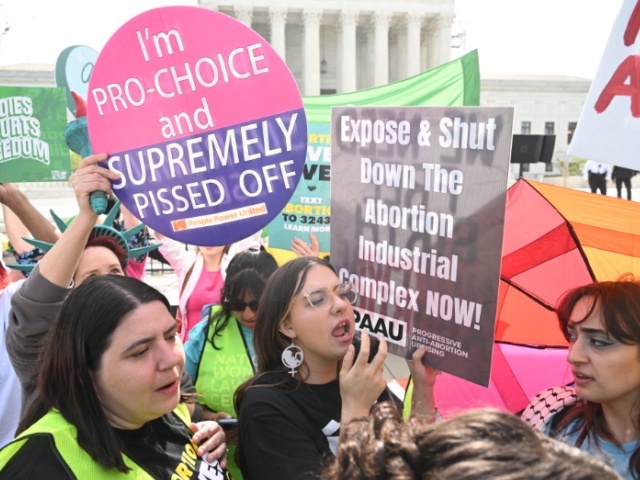 Pro-abortion activists rally for "reproductive rights and emergency abortion care" as anti-abortion activists also demonstrate, outside the US Supreme Court as it hears arguments in the Moyle v. United States case, in Washington, DC, on April 24, 2024. The case deals with whether an Idaho abortion law conflicts with the federal Emergency Medical Treatment and Labor Act (EMTALA). (Photo by SAUL LOEB / AFP) (Photo by SAUL LOEB/AFP via Getty Images)