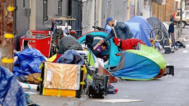 SAN FRANCISCO, CA - FEBRUARY 24: Homeless people consume illegal drugs in an encampment along Willow St. in the Tenderloin district of downtown on Thursday, Feb. 24, 2022 in San Francisco, CA. London Breed, mayor of San Francisco, is the 45th mayor of the City and County of San Francisco. She was supervisor for District 5 and was president of the Board of Supervisors from 2015 to 2018. (Gary Coronado / Los Angeles Times)