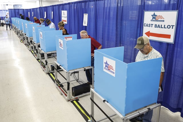 Voters fill out their ballots on the second day of early voting in the 2024 presidential election at the Board of Elections Loop Super Site in Chicago, Illinois, on October 4, 2024. (Photo by KAMIL KRZACZYNSKI / AFP) (Photo by KAMIL KRZACZYNSKI/AFP via Getty Images)