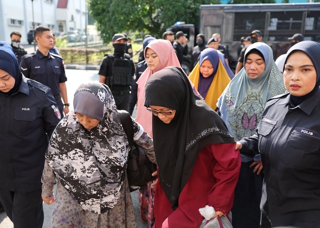Members of Global Ikhwan Services and Business Holdings (GISB) arrive at the Selayang court to face charges, in Selayang, Malaysia October 23, 2024. REUTERS/Hasnoor Hussain