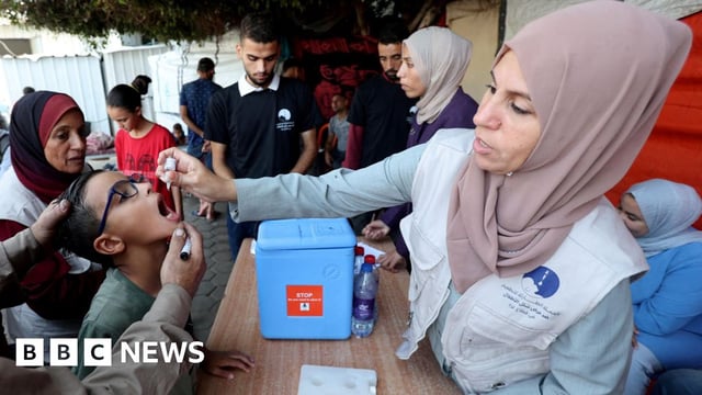 A healthcare worker gives an oral polio vaccine to a child in Deir al-Balah, central Gaza (15 October 2024)