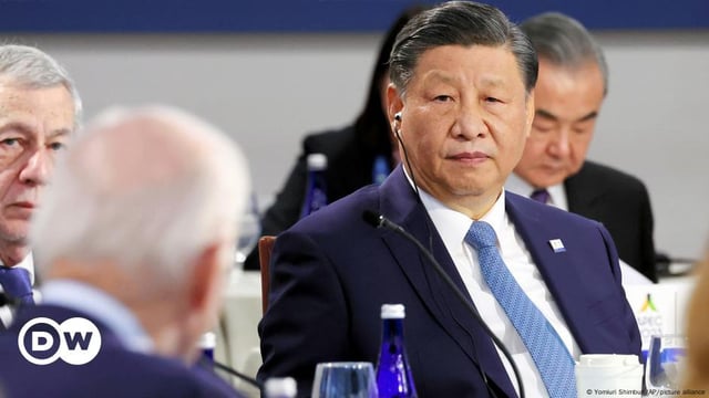 Xi Jinping listens to Joe Biden during a summit in 2023