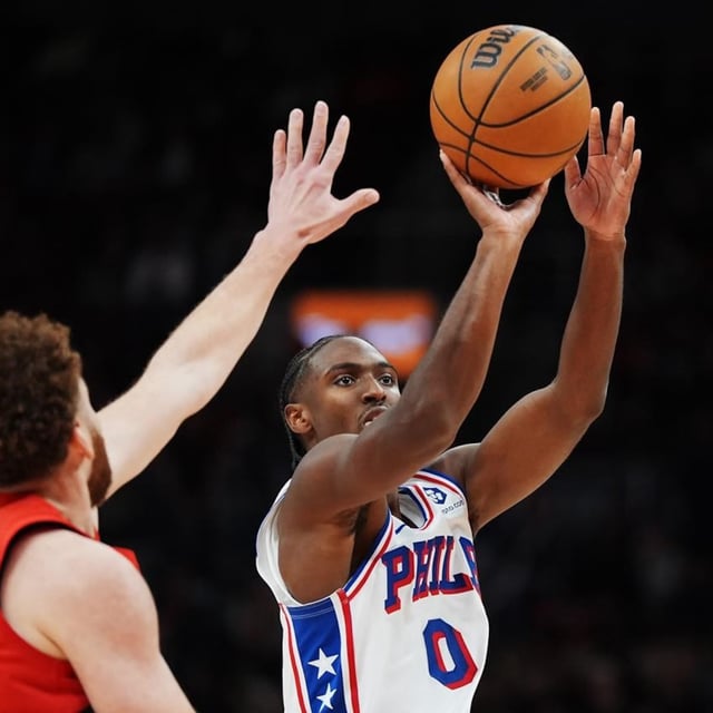 Philadelphia 76ers guard Tyrese Maxey (0) shoots past Toronto Raptors forward Jamison Battle (77) during second half NBA basketball action in Toronto on Friday, October 25, 2024. THE CANADIAN PRESS/Frank Gunn