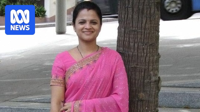 Prabha Kumar, smiling at the camera in a bright pink and gold traditional outfit.