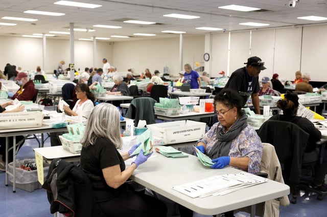 Election workers open mail in ballots in Phoenix,  on Nov. 11, 2022. 