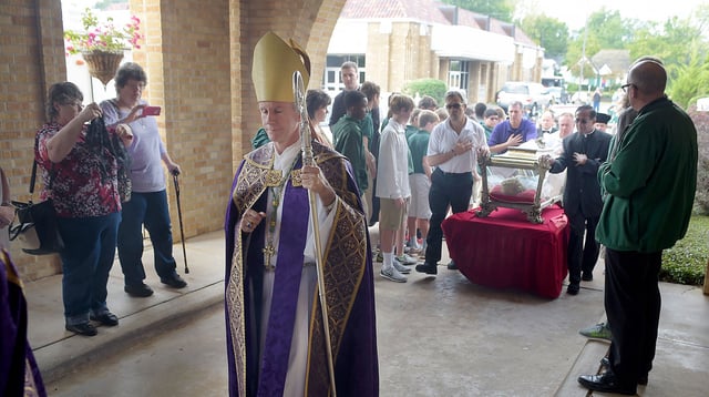 FILE - Bishop Joseph Strickland walks in front of a reliquary bearing the bones of Saint Maria Goretti, dubbed "The Little Saint of Great Mercy," as it is wheeled past parish members and into the sanctuary at Cathedral of the Immaculate Conception on Monday, Nov. 2, 2015, All Souls' Day, in Tyler, Texas.