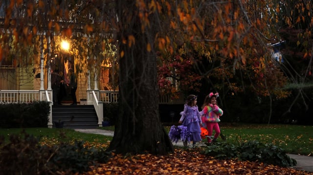 Children go trick or treating in the New York suburb of Upper Nyack, New York, on October 31, 2023.