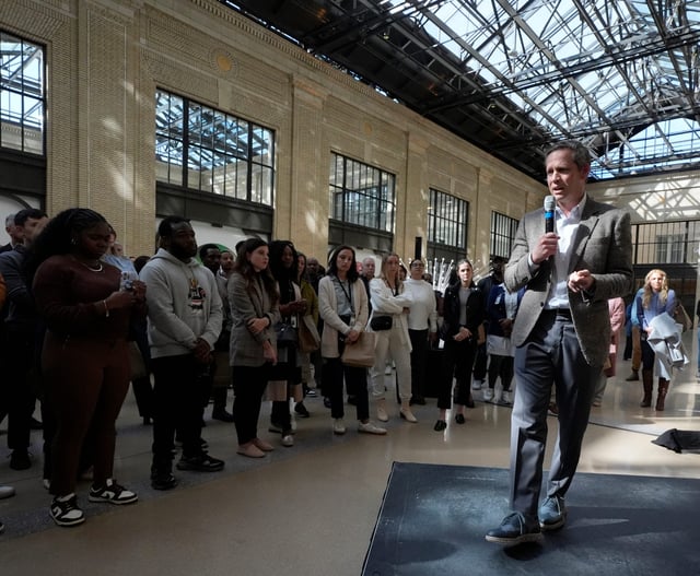Peter Stern, the president of Ford Integrated Services, talks to Ford Motor Company employees inside Michigan Central on their first day of work at the renovated train station on Tuesday, October 8, 2024.