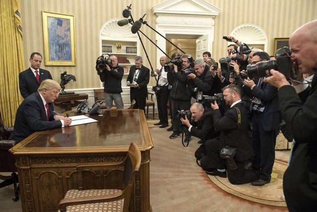 In this January 20, 2017 photo, then-President Donald Trump signs an executive order commanding federal agencies to try to waive or delay requirements of former President Barack Obama's health-care law, the Affordable Care Act (ACA), in the Oval Office of the White House in Washington, DC.