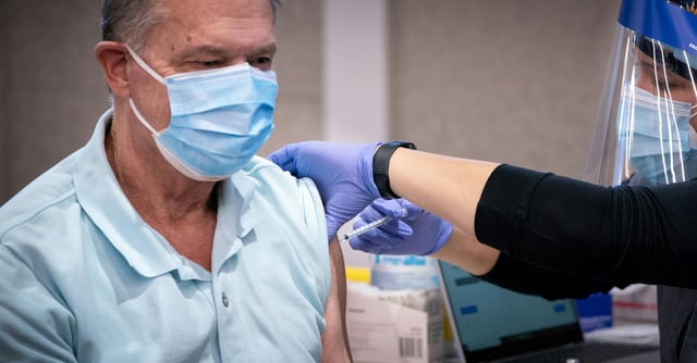 Ron Tupy of Apple Valley, Minnesota receives his shot of COVID vaccine from Registered Nurse Darcey McCampbell. Minnesota state officials this week launched test clinics at nine sites across Minnesota, including this one in Brooklyn Center, to provided limited vaccine access to people 65 and older, as well as teachers and child-care workers. (Glen Stubbe/Minneapolis Star Tribune/TNS) ORG XMIT: 7429888W